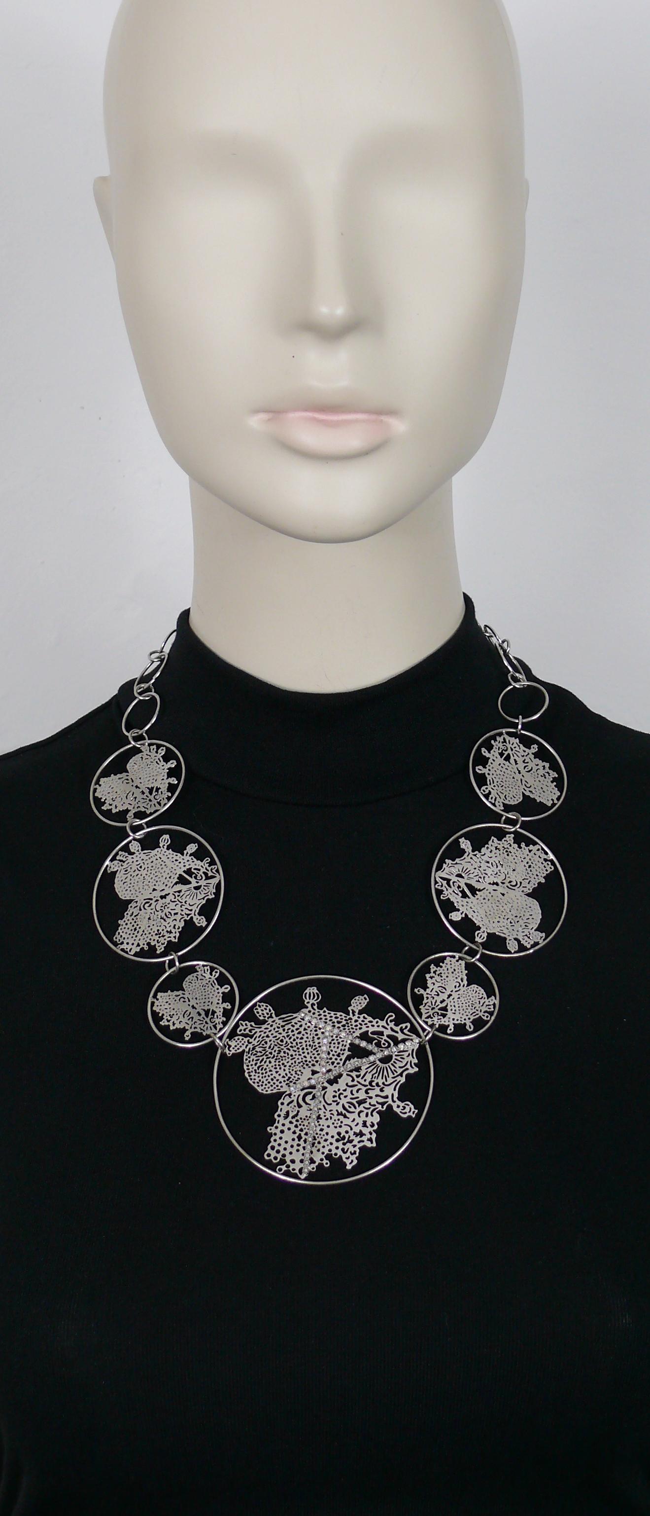 CHRISTIAN LACROIX vintage silver toned necklace featuring seven laser cut stylized heart medallions and crystal embellishement.

Silver tone metal hardware.

Monogram CL signature on each medallion (see example on the last picture).

T-bar