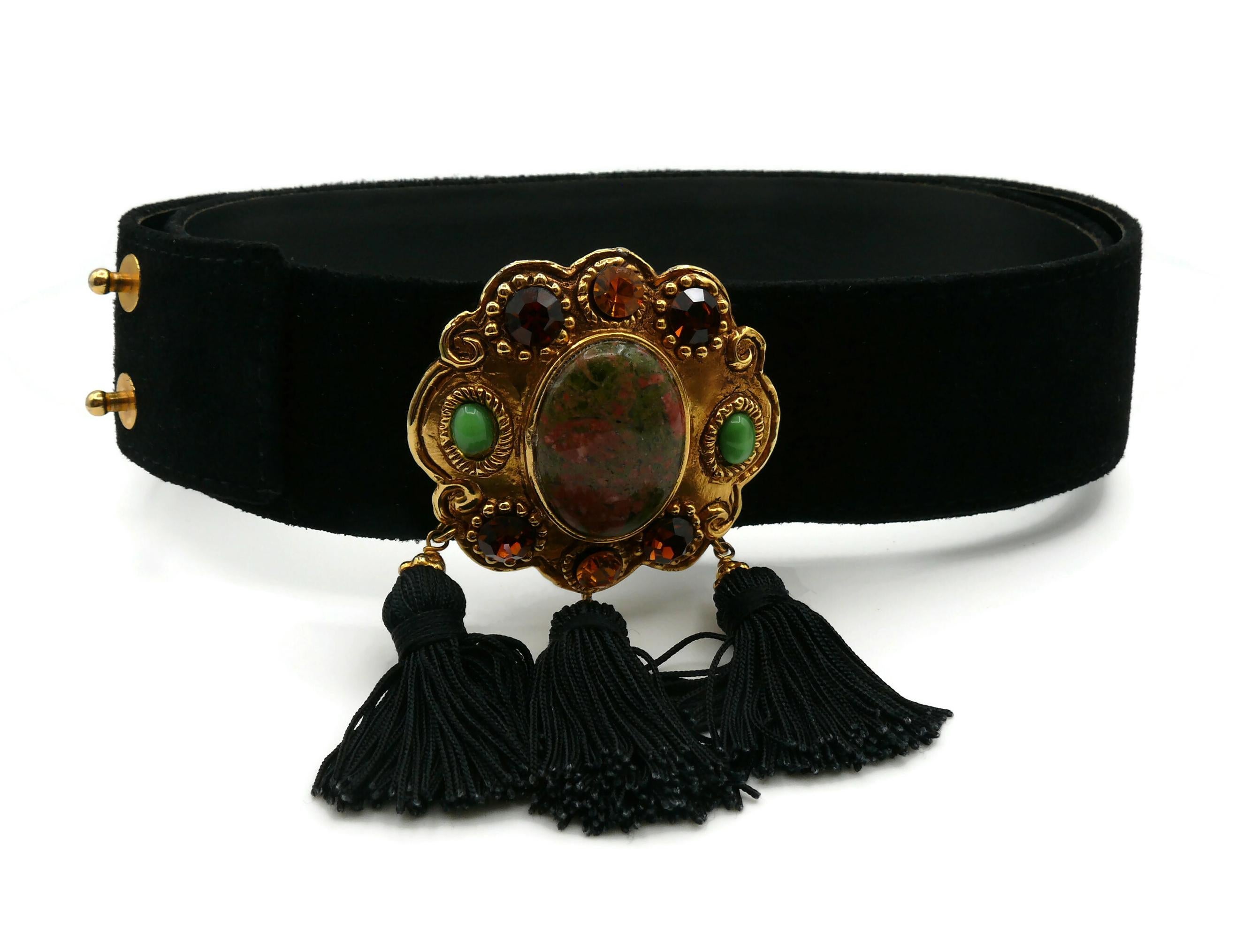 CHRISTIAN LACROIX vintage black suede leather belt featuring an antiqued gold tone medallion embellished with multicolored crystals, green glass beads, a large marbled faux stone at the center and three black tassels.

Marked CHRISTIAN LACROIX