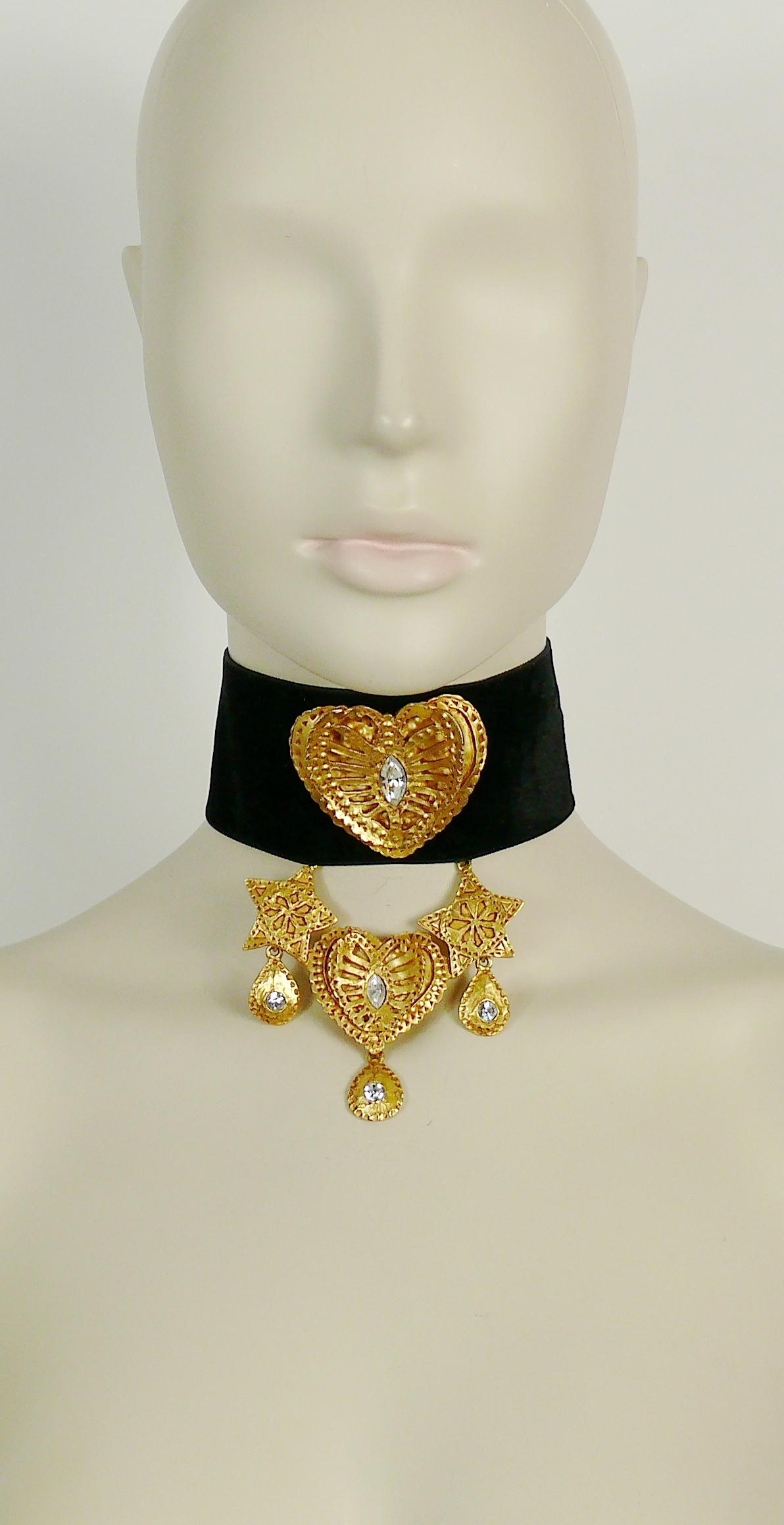 CHRISTIAN LACROIX documented vintage rare black velvet choker necklace featuring textured gold toned stars, hearts and charms with clear crystal embellishement.

Similar model worn by super model CHRISTY TURLINGTON at the CHRISTIAN LACROIX