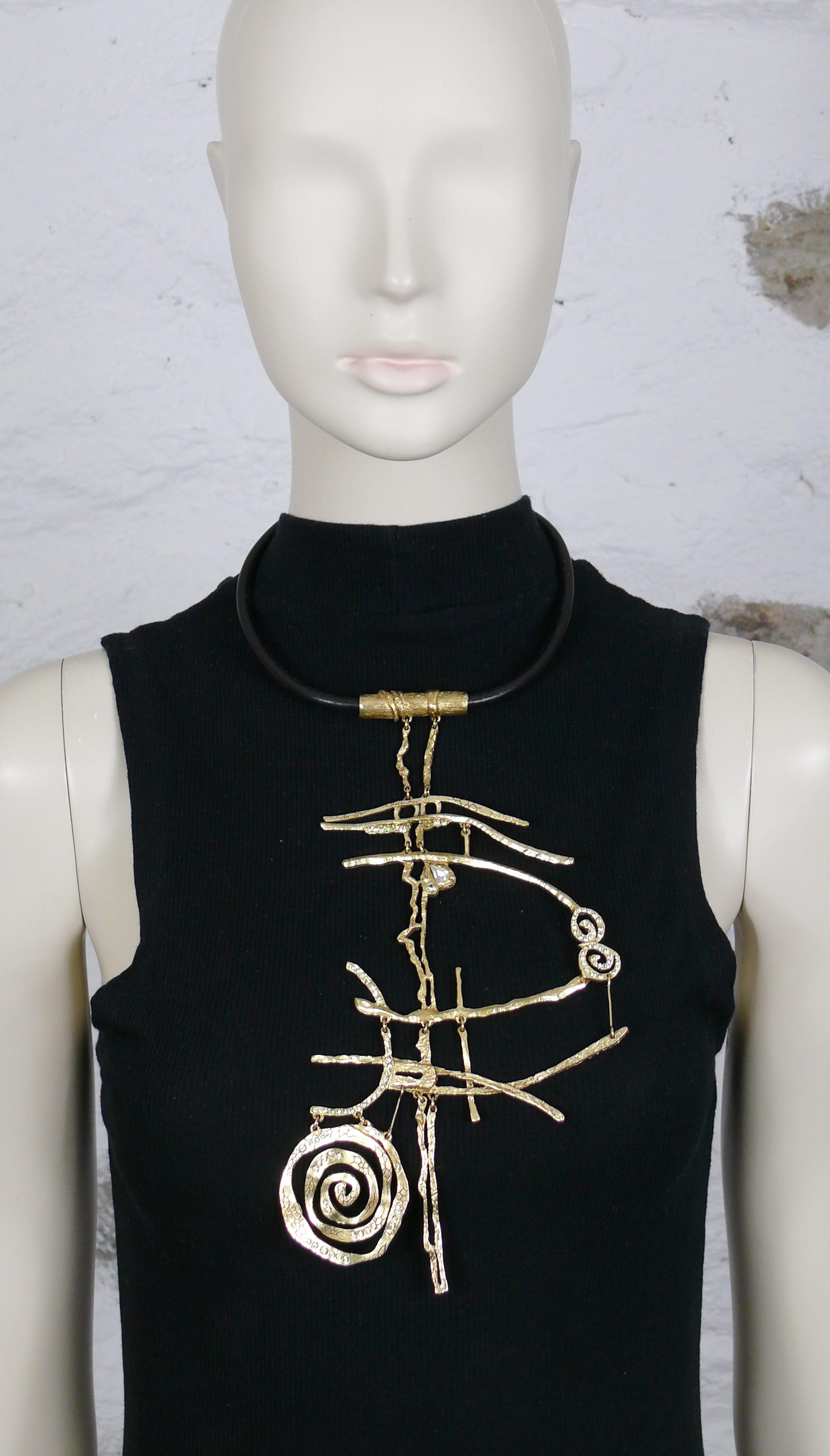 CHRISTIAN LACROIX vintage antiqued gold toned necklace featuring a black leather cord collar and an asymetric brutalist plastron pendant embellished with jonquil color crystals.

T bar and toggle closure.

Marked CHRISTIAN LACROIX CL Made in