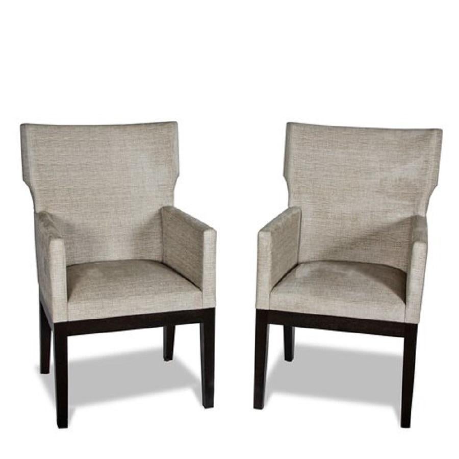A pair of Barbuda Armchairs by Christian Liaigre for Holly Hunt.

Upholstered in fabric, complemeted by dark wood stained legs.