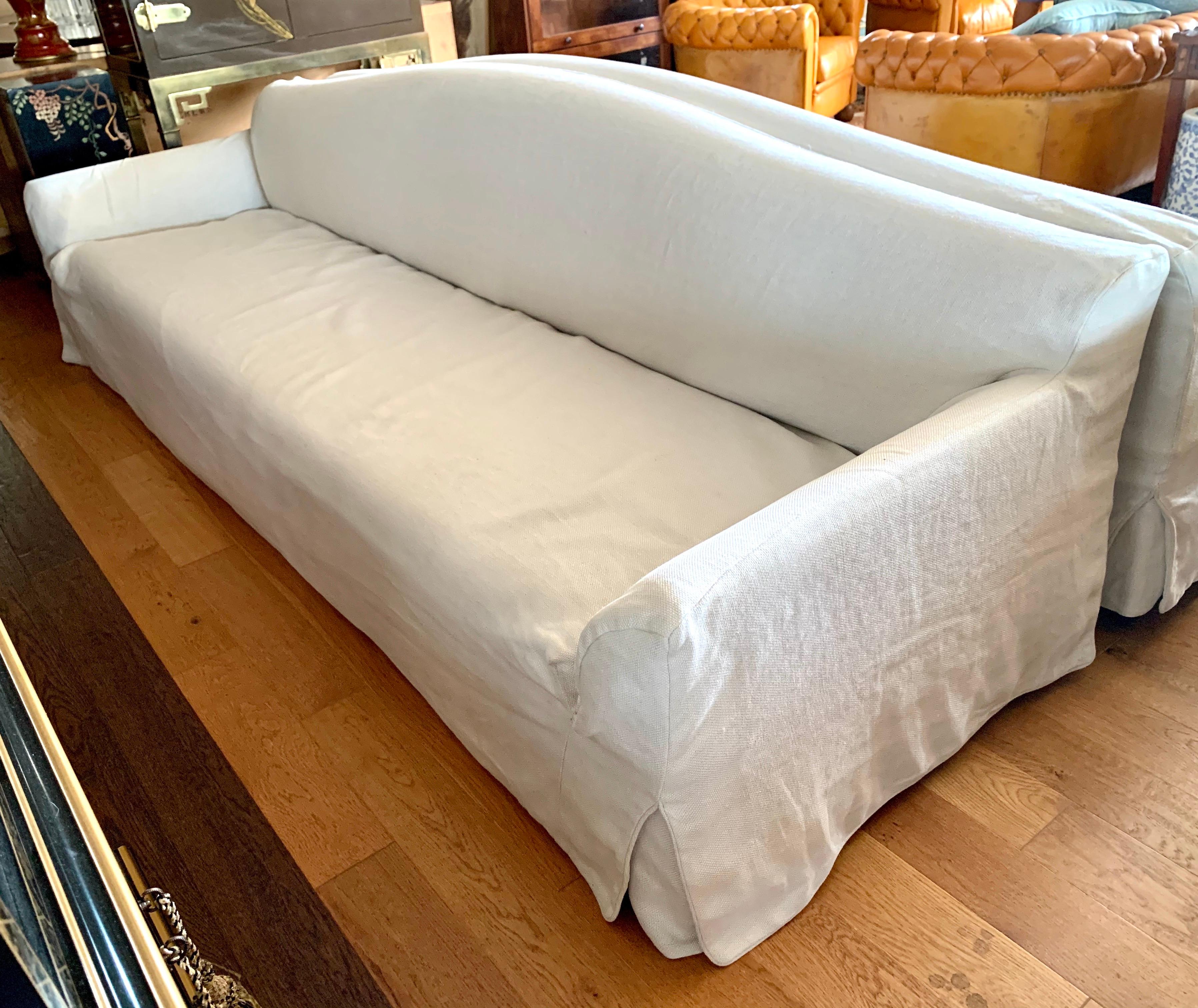 Elegant, large, Christian Liaigre terra linen sofa for Holly Hunt with removable slipcover.  It features a camelback backrest which gives this transitional beauty a classic look.
All manufacturing hallmarks present underneath.
