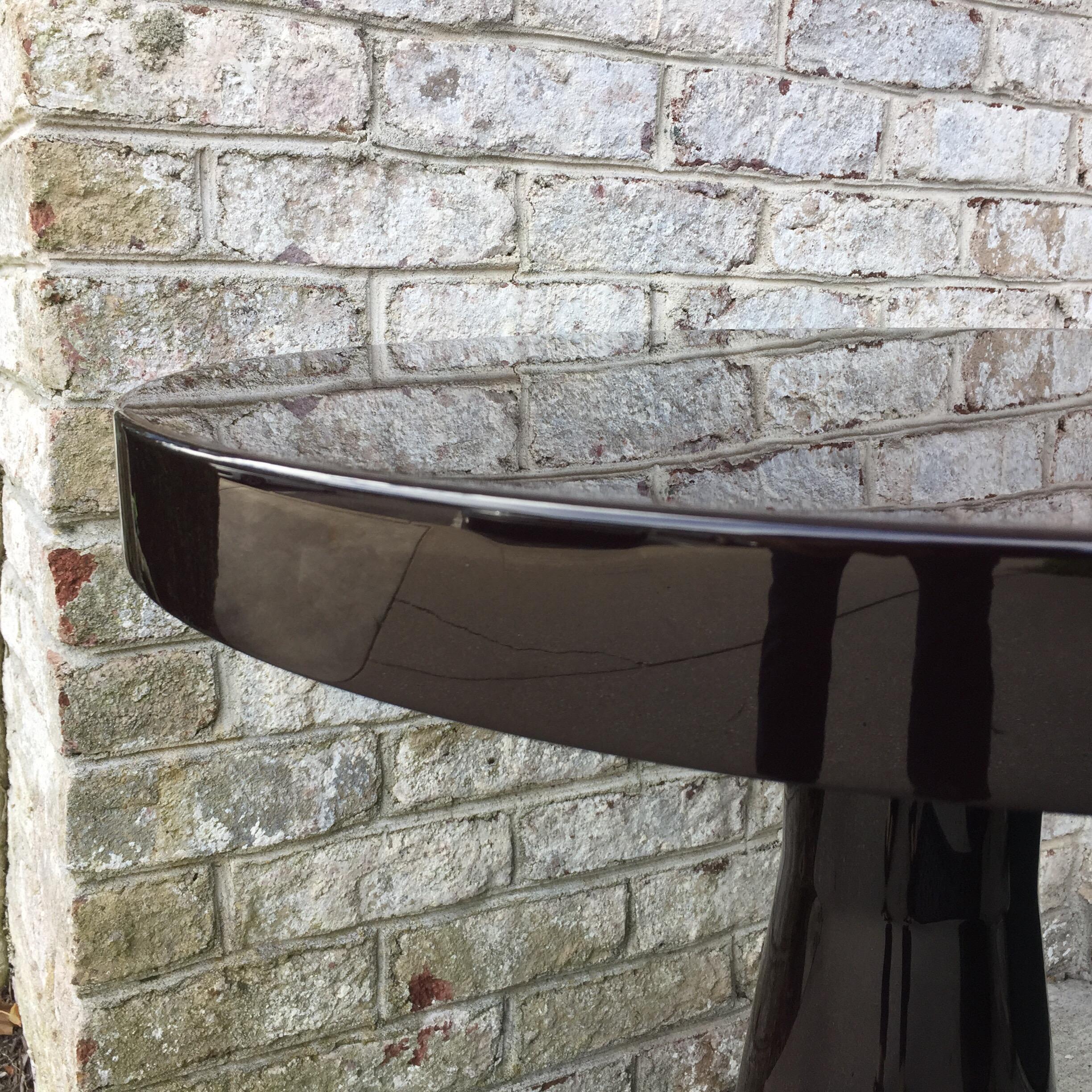 This is a lovely and well preserved round top lacquered side table by Christian Liaigre. It is a rich deep brown. Metal tag to the underside.