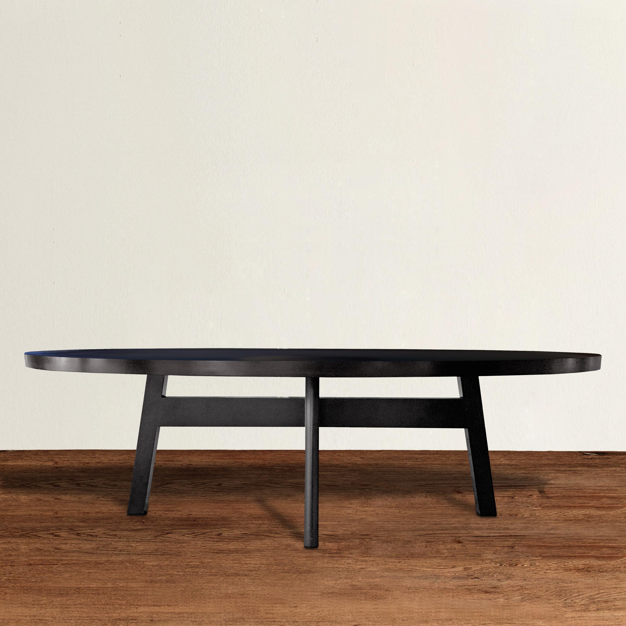 A wonderfully chic Christian Liaigre designed for Holly Hunt custom oak oval dining table with a simple cross-stretcher base with four legs, and a dark ebony stained finish. This table has a classical form that honors the past with strong lines that