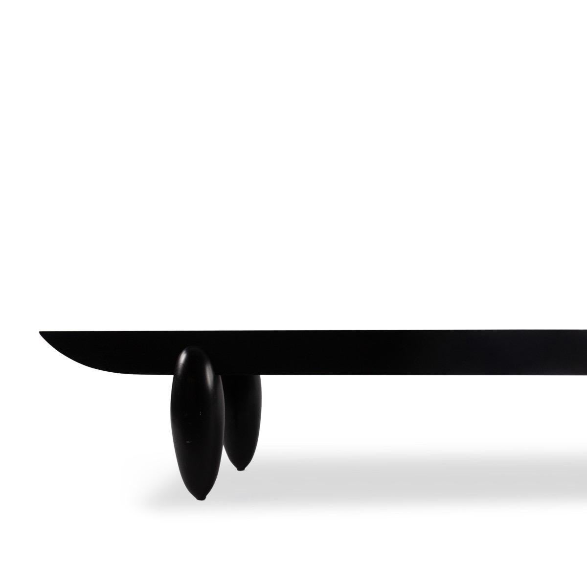 An original Christian Liaigre long bench or low table in ebonized wood.

Dimensions: 72