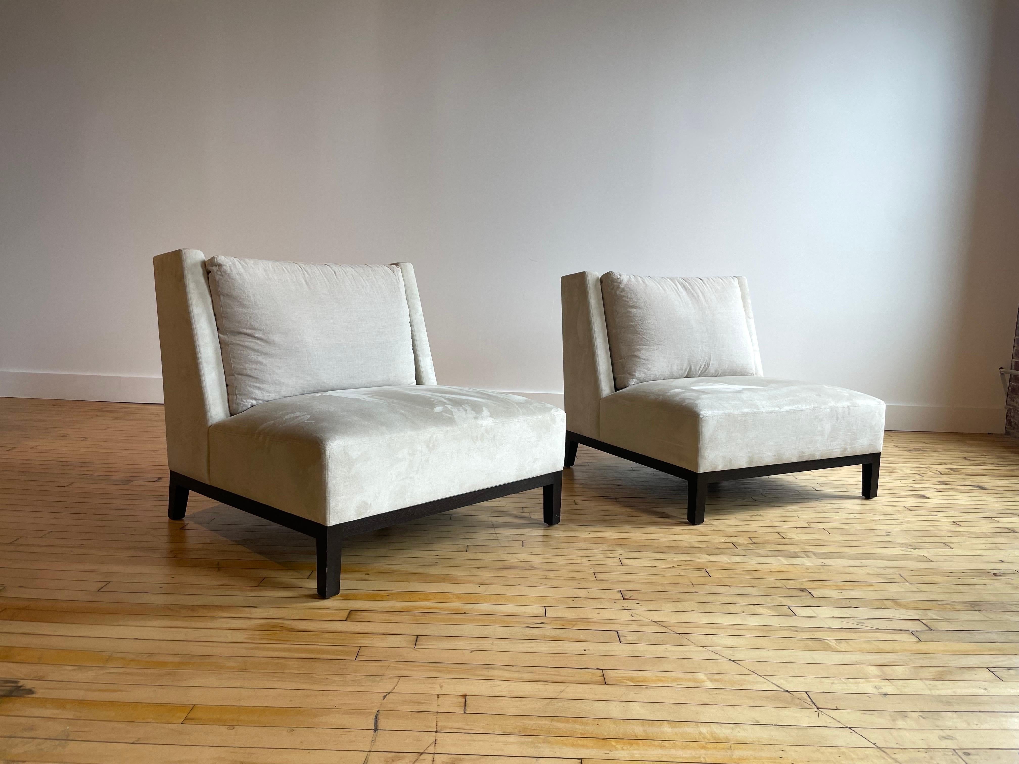 A pair of large beautiful ivory suede slipper chairs raised on exposed espresso wooden legs with single detached ivory linen back cushion. 

From luxury manufacturer Holly Hunt. 


Height: 32.25 inches / 81.92 cm
Width: 35.5 inches / 90.17 cm
Depth: