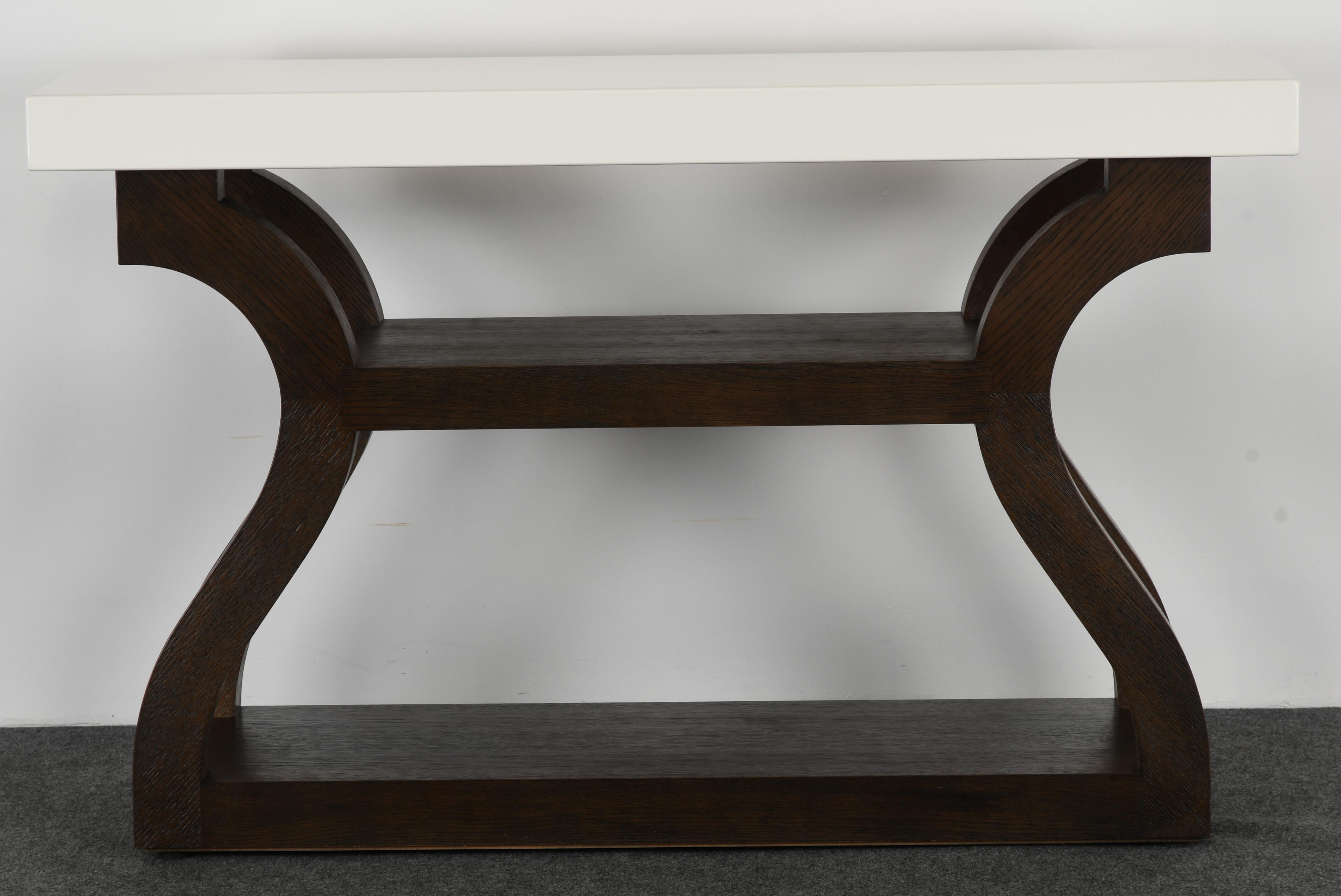 A stunning Christian Liaigre console for Holly Hunt, 20th century. This console table is finished in an espresso stained oak and lacquered wood. The table is structurally sound and in very good condition. 

Dimensions: 33.75