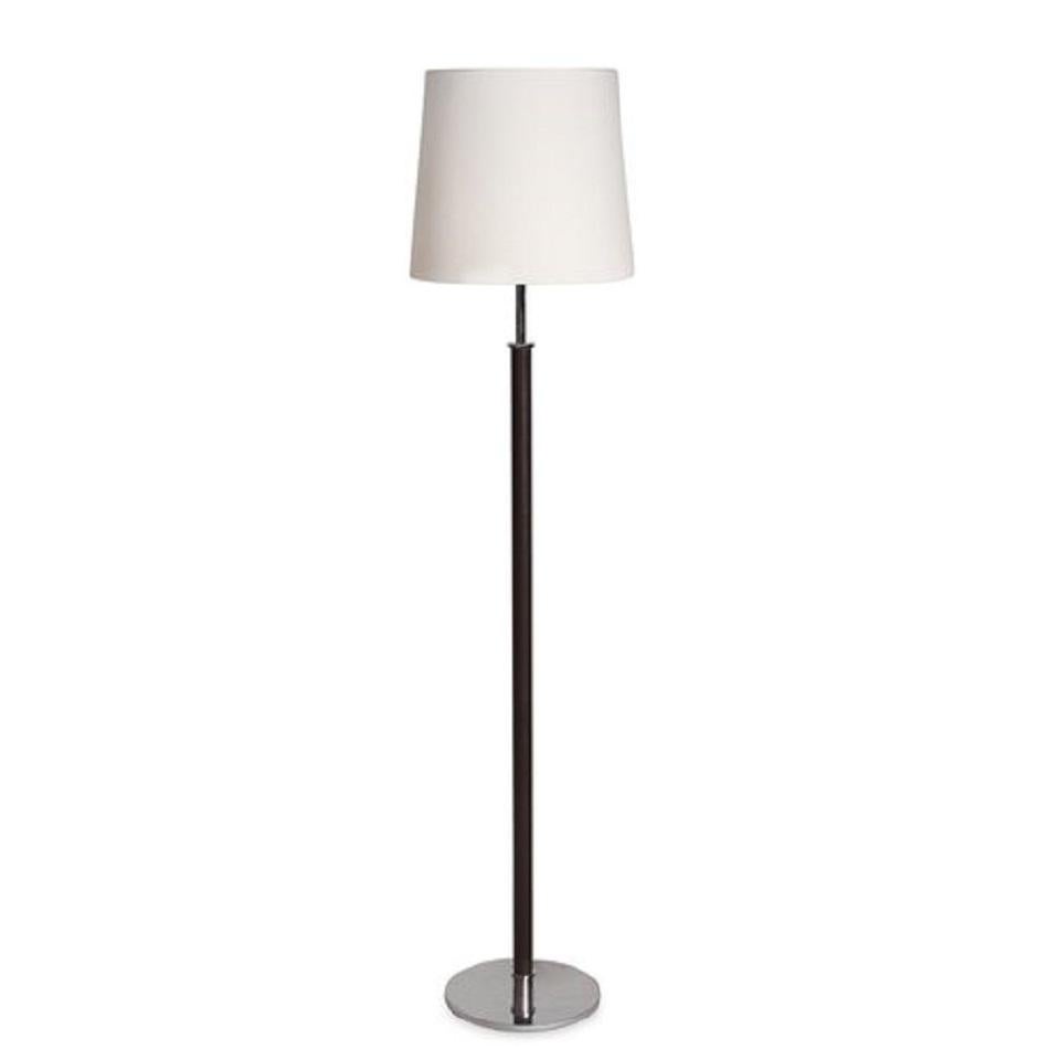 A Christian Liaigre floor lamp inspired by the world of horse riding. 

Features a chromed brass base decorated with leather and saddle stitching.

 Dimensions: 13”L x 13”W x 57”H.