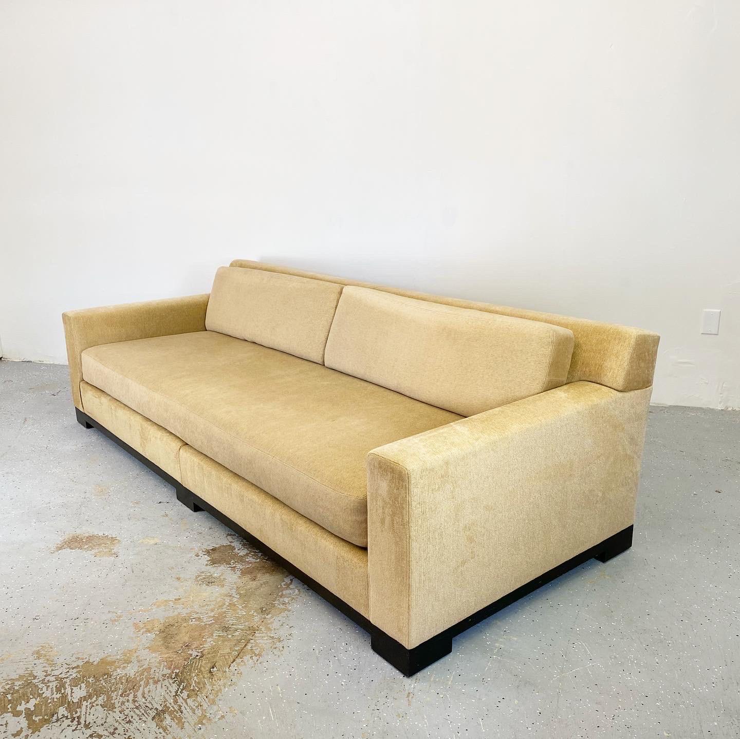 Luxurious pair of sofas by Holly Hunt designed by Christian Liaigre, priced individually. These are each two pieces for ease of install. Beautiful minimal design with thick cushions and deep seat offering plenty of comfort. In need of new upholstery.