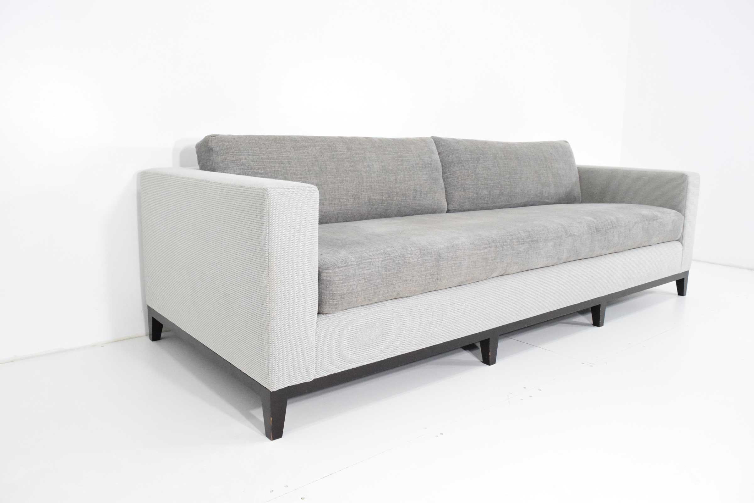 A beautiful clean lined sofa by Christian Liaigre for Holly Hunt. Extremely well constructed and of the highest quality. Sofa would benefit with new upholstery which we recommend. Espresso stained wood base.