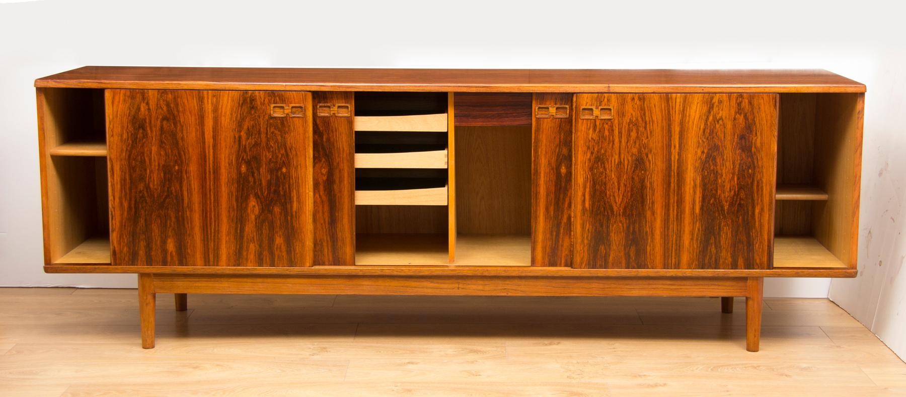 Christian Linneberg rosewood Danish sideboard, circa 1960 with four sliding doors featuring finger pull handles revealing fitted interior.
