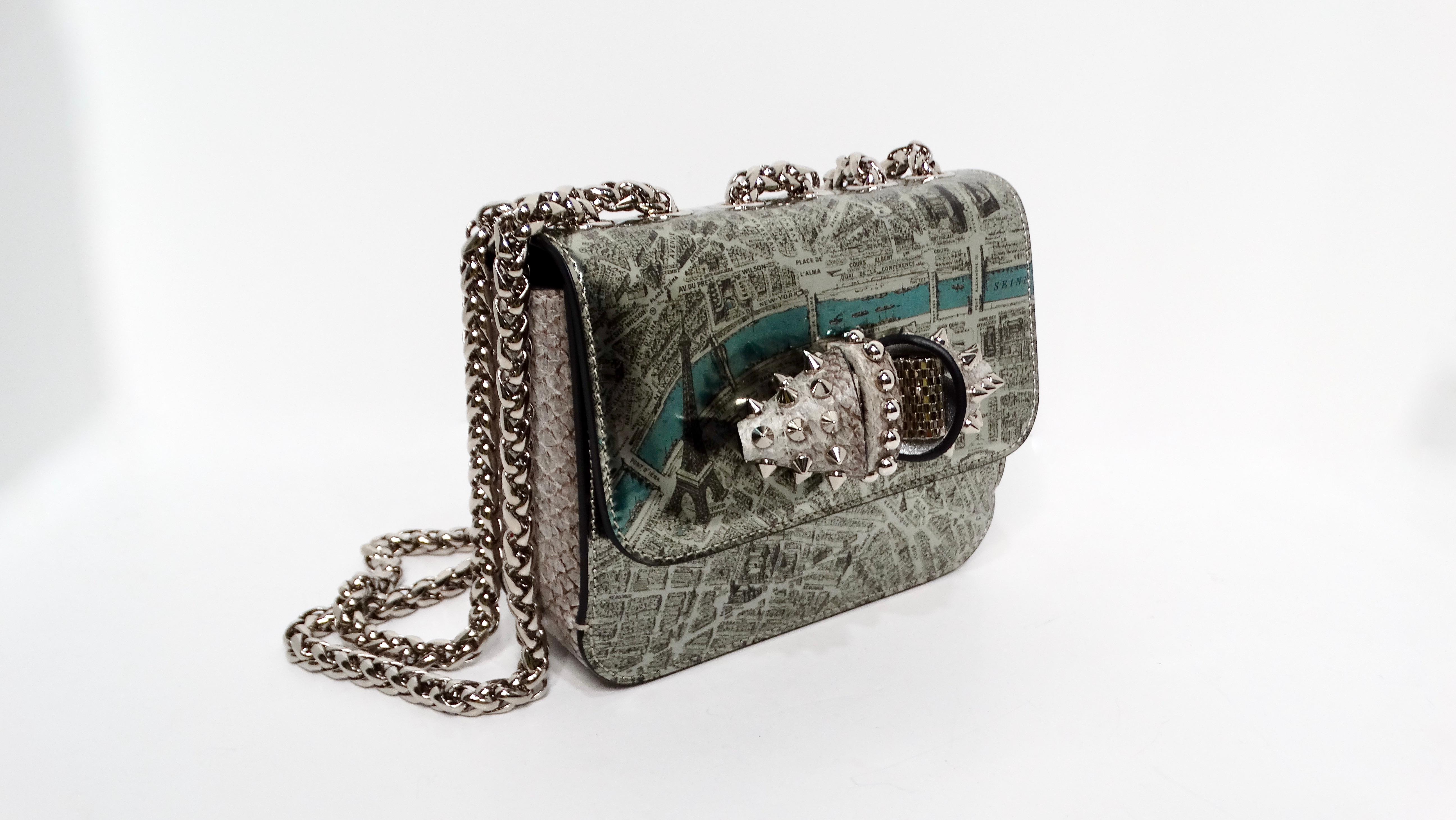 Elevate your accessory collection with the Christian Louboutin 2016 Sweet Charity De Paris Pattern Shoulder Bag, a stunning blend of whimsy and luxury. Crafted from exquisite silver patent leather, this enchanting bag showcases a beautifully printed