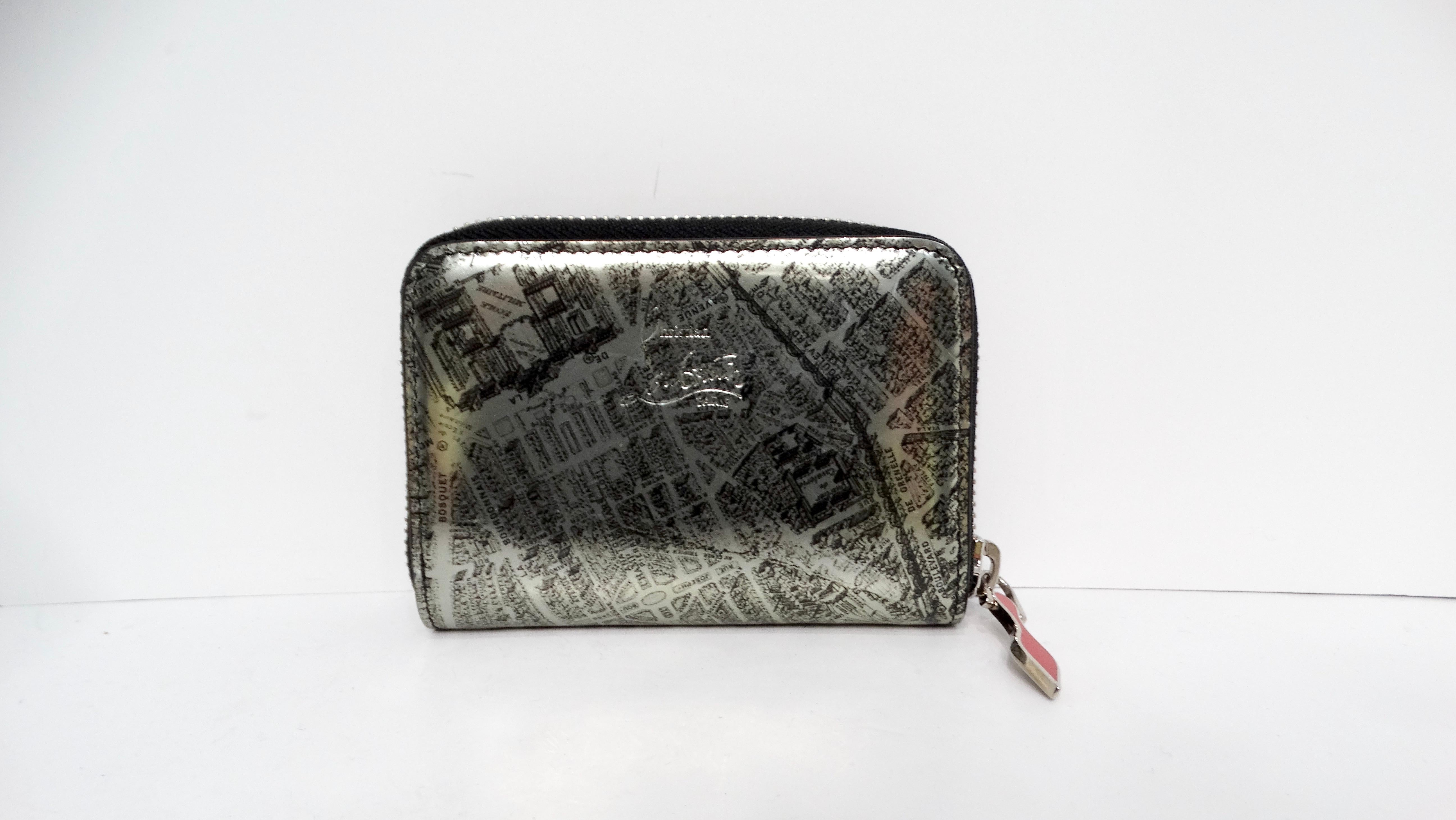 Add a touch of Parisian charm to your accessories collection with the Christian Louboutin 2016 Sweet Charity De Paris Pattern Zip Coin Purse, a delightful and miniature companion to the iconic Sweet Charity handbag. Crafted from luxurious patent