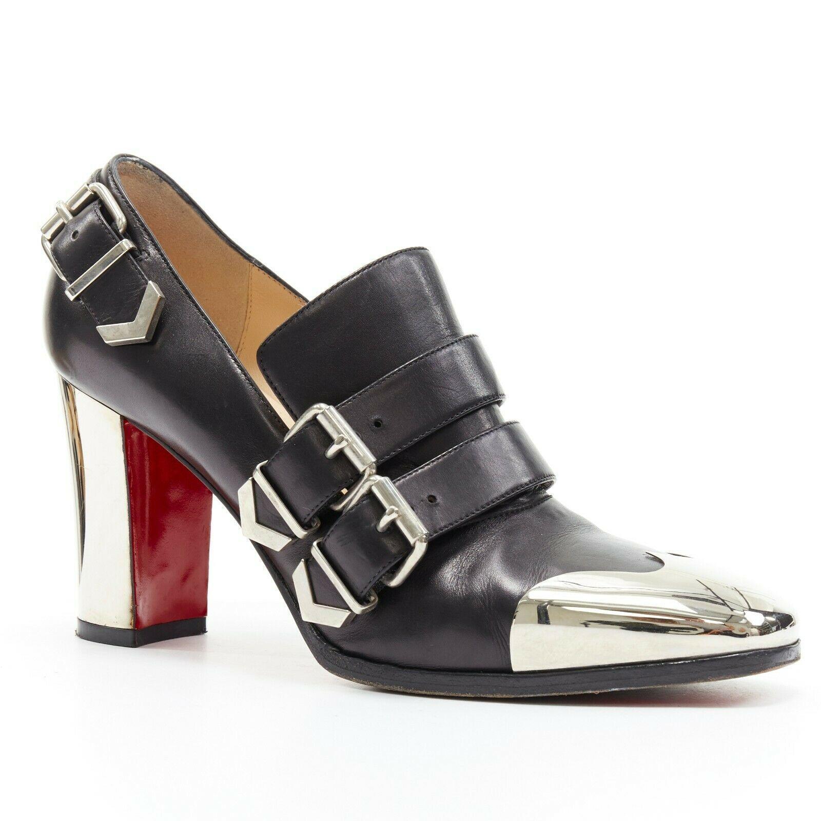 CHRISTIAN LOUBOUTIN  Anita 85 black metal square toe dual strap bootie EU39
CHRISTIAN LOUBOUTIN
Anita 85. 
Black leather upper. Dual decorative strap across vamp. 
Silver-tone hardware. Square toe. 
Silver metal toe cap. Metal chunky heel. 
Padded