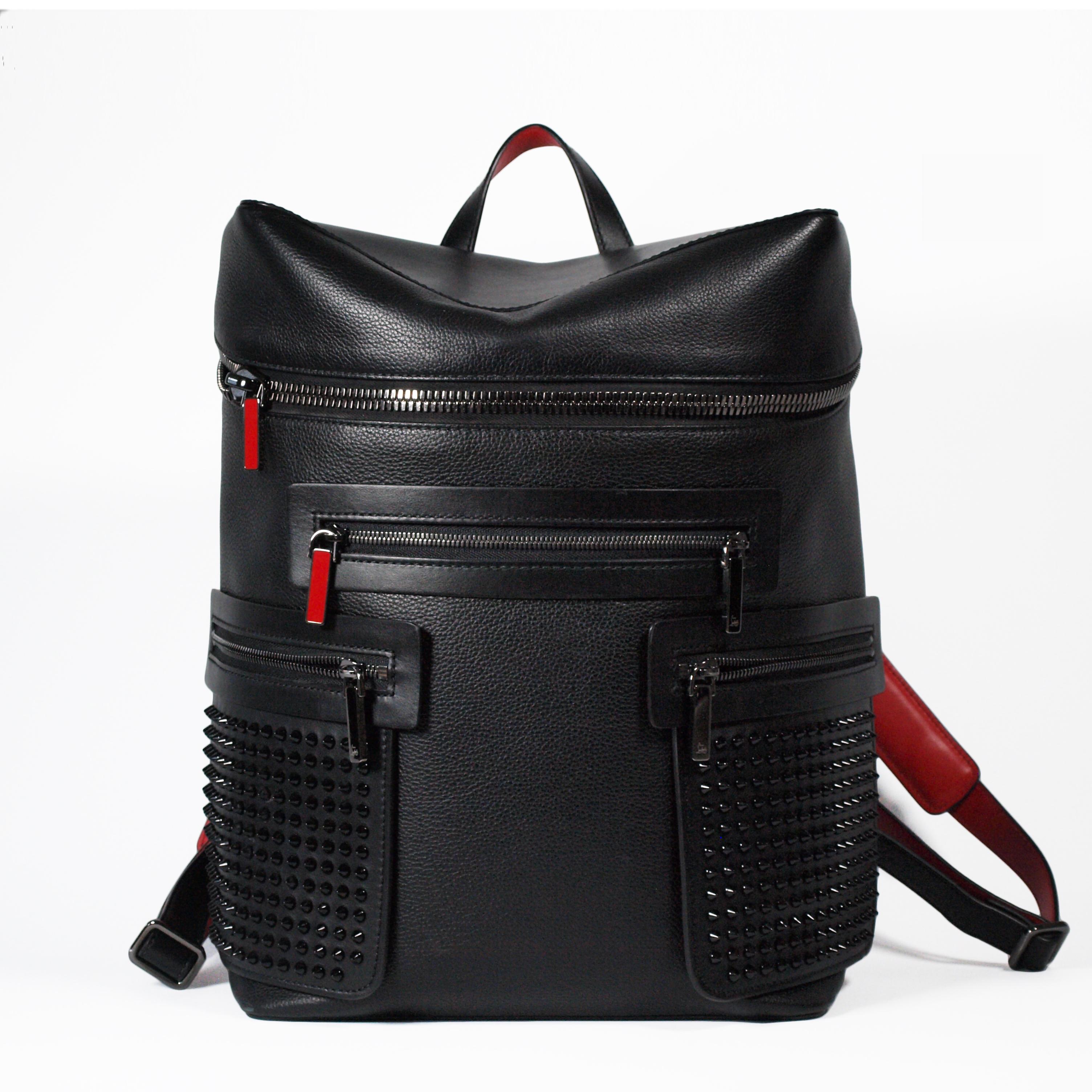 A Christian Louboutin Apoloubi backpack.
Embellished with signature gunmetal studs which match the zip-fastening side pocket panels. The smooth top handle and padded shoulder straps are complete with a vibrant Louboutin red reverse side, which is