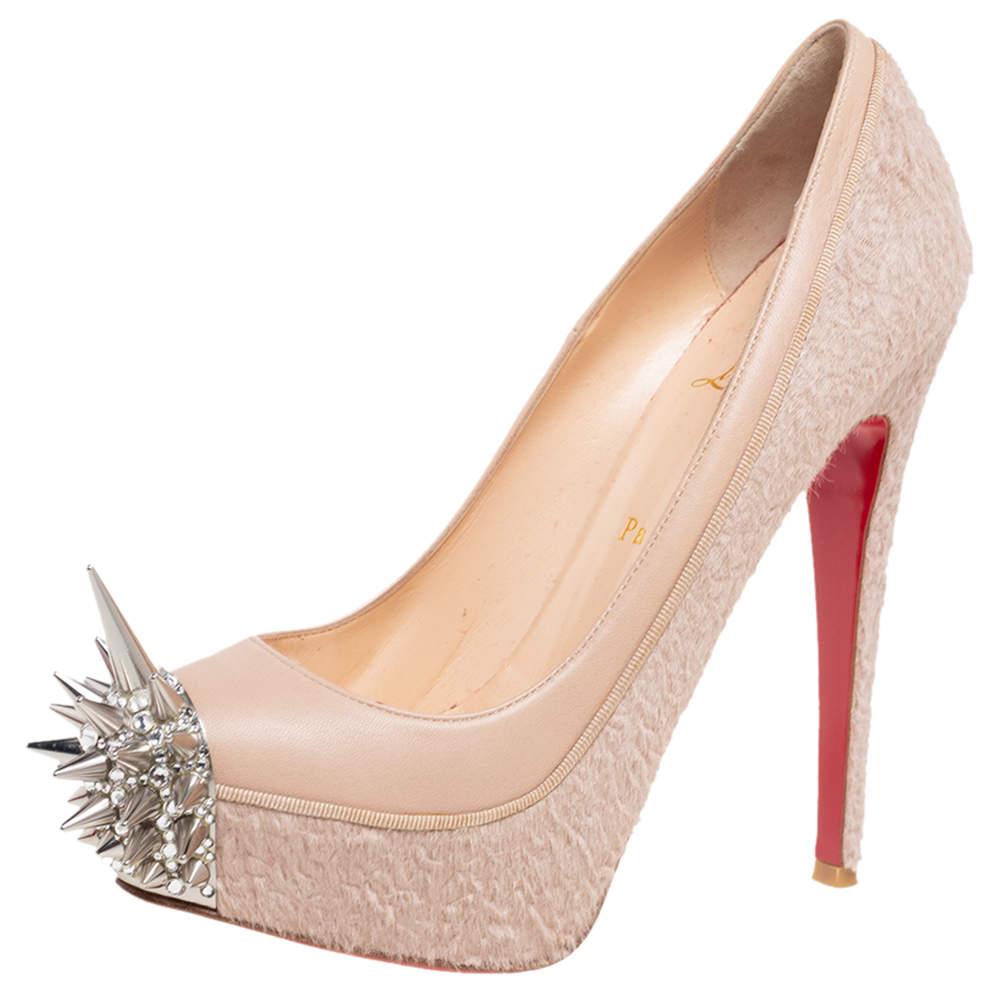 Jazz up your everyday attire with this pair of classic pumps, designed by Christian Louboutin. Crafted from leather and calf hair, these are styled with platforms, high heels, and metal spikes on the toes. This pair of black beauties flaunt a