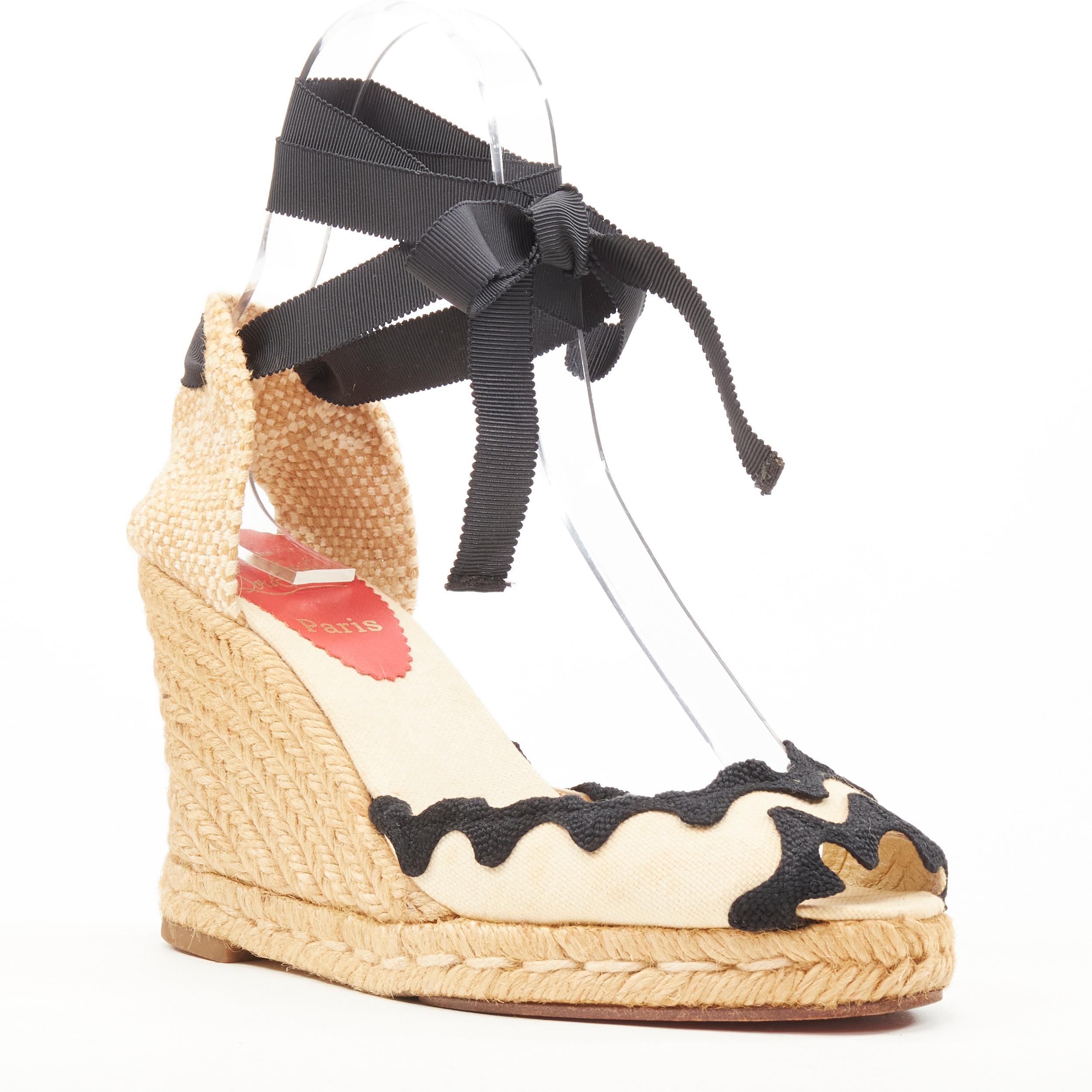 CHRISTIAN LOUBOUTIN beige canvas black scalloped espadrille wedge heel EU37 
Reference: SNKO/A00188 
Brand: Christian Louboutin 
Material: Canvas 
Color: Beige 
Pattern: Solid 
Closure: Ribbon tie 
Extra Detail: Brown canvas upper. Woven heel.