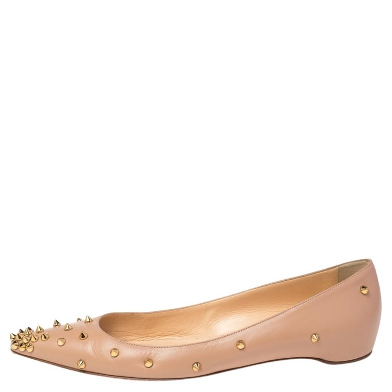 Be ready for constant attention and admirable gasps from your audience when you walk in these flats from Christian Louboutin. Crafted from beige leather, they carry pointed toes and spikes decorated all over. The pair is complete with leather