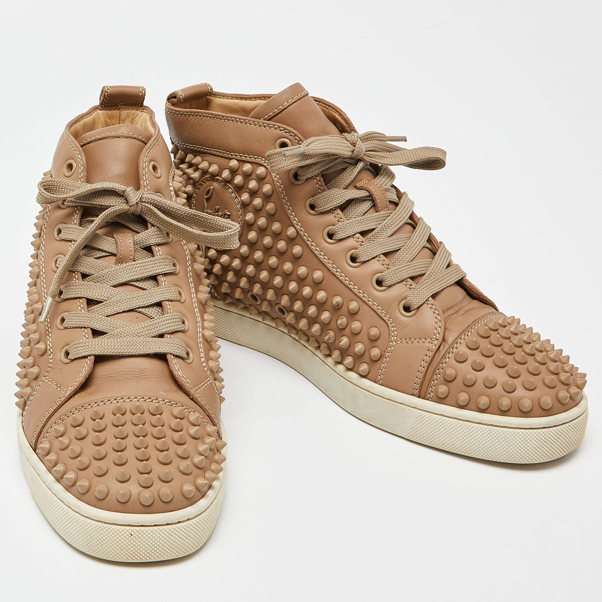 Christian Louboutin infuses its creations with attractively rare designs that keep them high on appeal and trend. These Louis Spikes high-top sneakers is such a design. They have been crafted using leather with gold-toned spikes adorning the