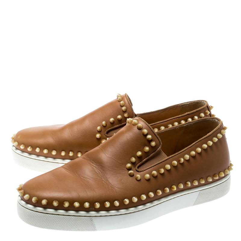 Add a unique style statement to your look with these eye-catching and fashionable Christian Louboutin Pik Boat slip-on sneakers. Constructed in beige leather, these shoes feature chunky rubber soles and spikes on the exterior.

Includes: Original