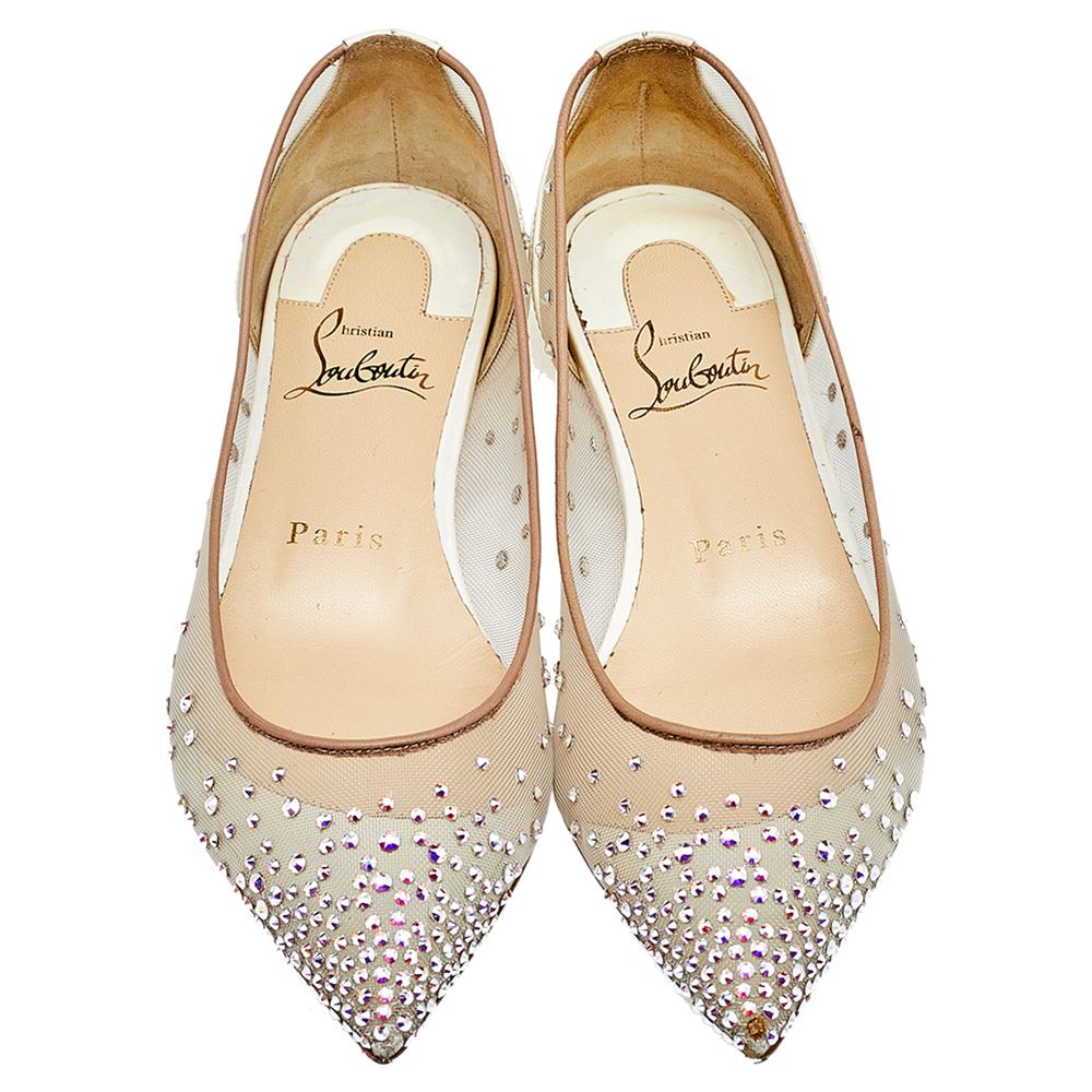 Inspired by the famous Parisian cabaret 'Follies Strass,' Christian Louboutin has crafted these iconic ballet flats into a distinguishing silhouette. They are made from beige mesh, leather, and iridescent patent leather, with the crystals