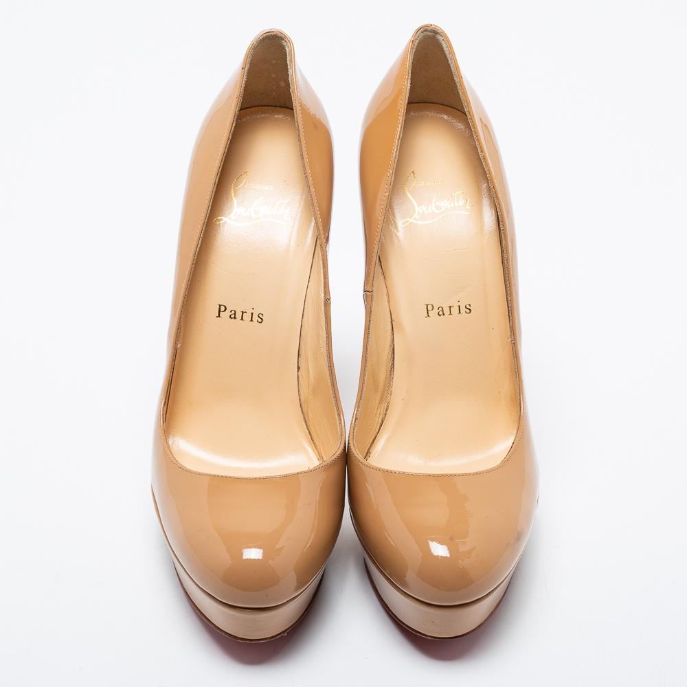 A classic to add to one's shoe collection is this elegant beige pair. These Christian Louboutin pumps are covered in patent leather and styled with platforms, 13 cm heels, and signature red soles. Add them to your closet today and flaunt them with