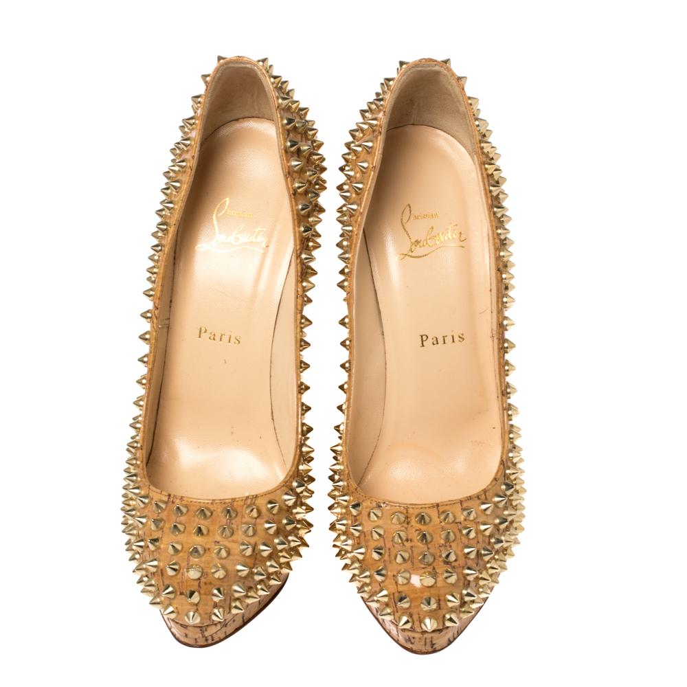 From the house of Christian Louboutin, this pair is an impeccable mix of comfort and bold style. Designed to perfection, this pair made in beige patent leather featuring a cork print and Alti spikes in gold-tone all over, offering an edgy touch to