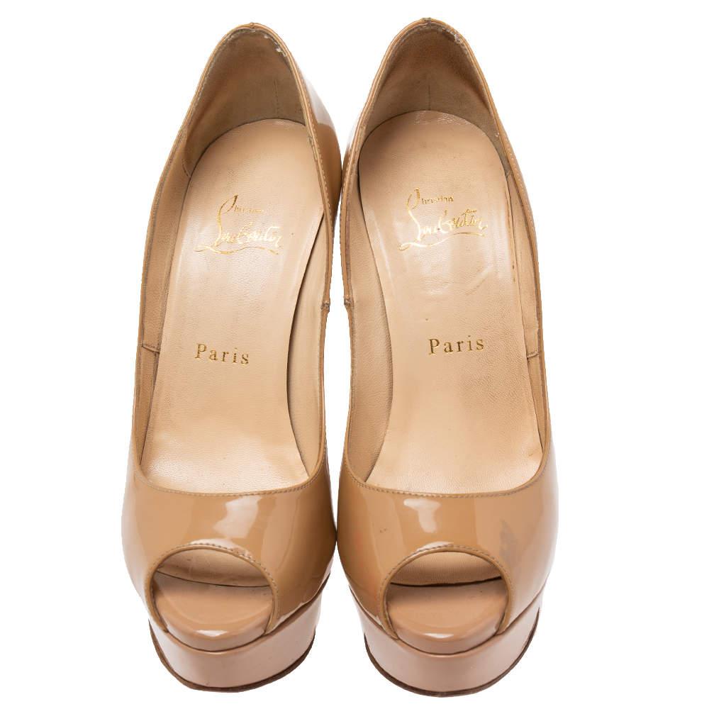 Crafted from beige patent leather, this pair is from CL's collection of amazing pumps. The shoes feature peep toes and 14 cm heels supported by platforms.


