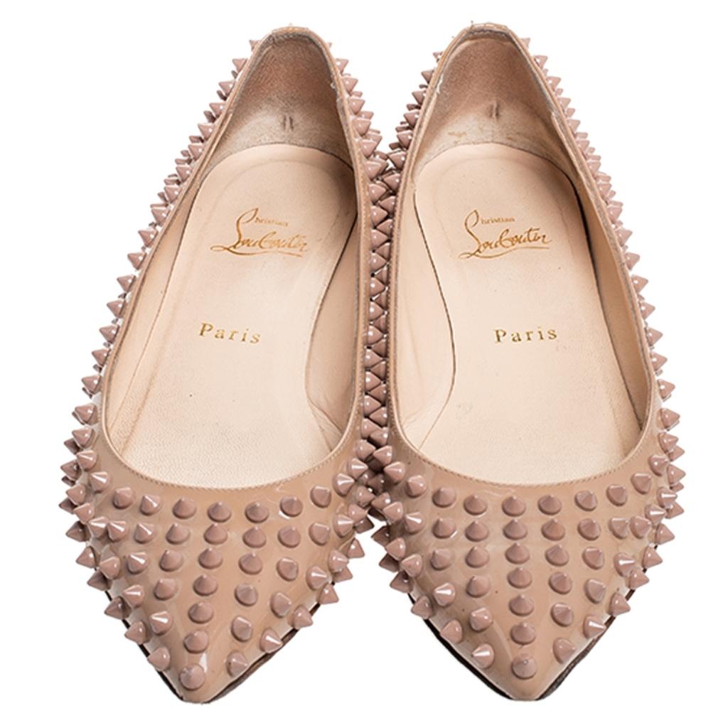 Crafted out of patent leather, these flats are a charming add-on accessory that you absolutely need to own. These ballet flats from the house of Christian Louboutin feature pointed toes, signature red soles and spikes all over the exterior.


