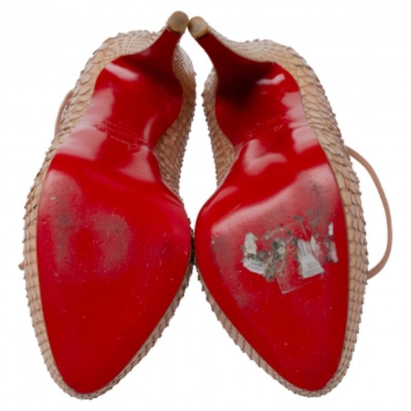 Beautifully designed, this pair of Bloody Mary pumps feature a python leather body. Made by Christian Louboutin, the beige pumps feature almond toes, lace-ups on the vamps that form ankle wraps, and 13.5 cm heels. Let your shoes essay your sense of