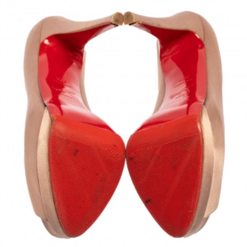 We've fallen head over heels in love with these pumps from Christian Louboutin! They are crafted from satin and styled with peep toes, platforms, and 13 cm stiletto heels. Truly high fashion, this beige pair will effortlessly bring out the