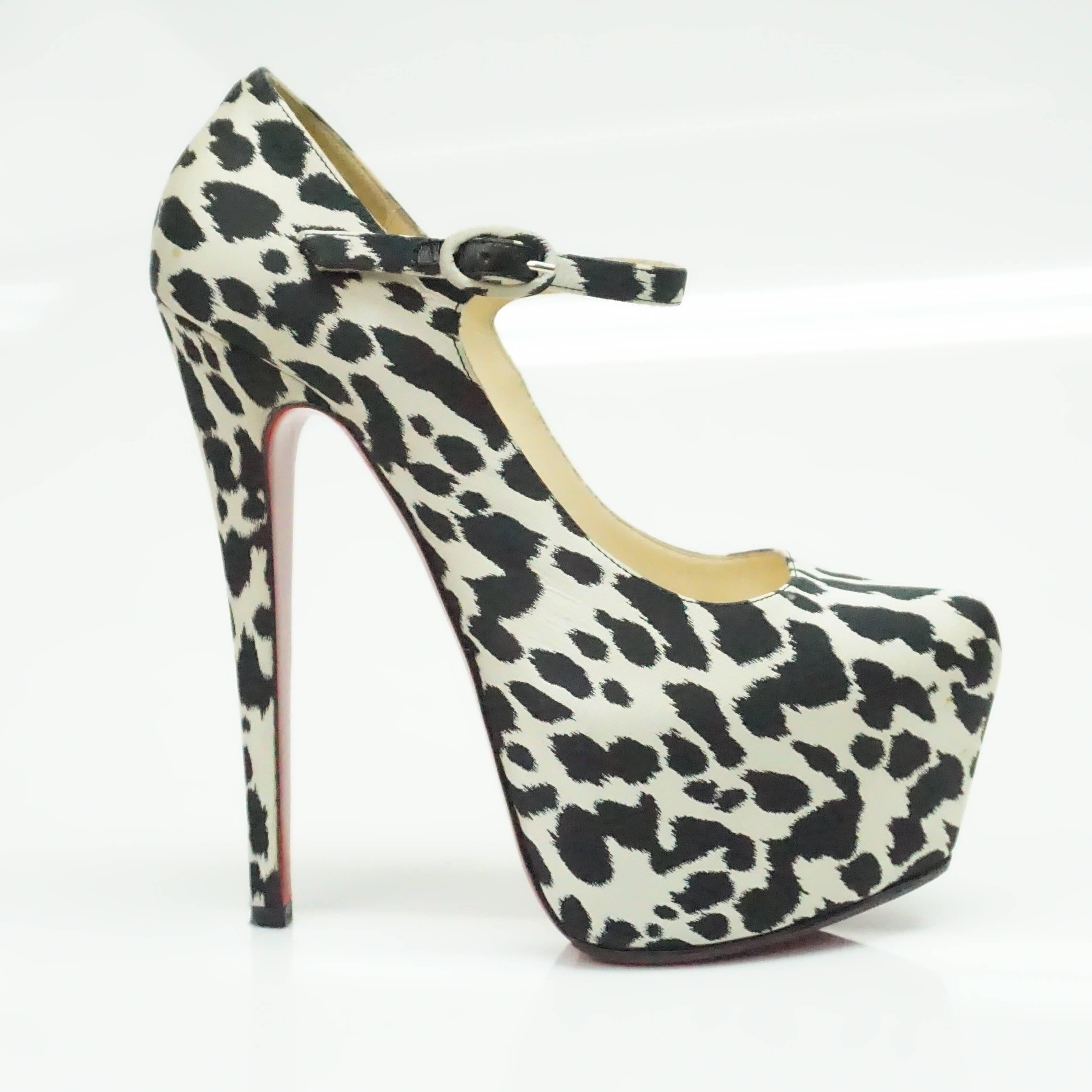 Christian Louboutin Black and White Lady Daf Leopard Mary Jane Pump -  36  These amazing leopard print pumps are in very good condition with some minor wear. The shoe is completely covered in a silk leopard print material and has an ankle strap. The
