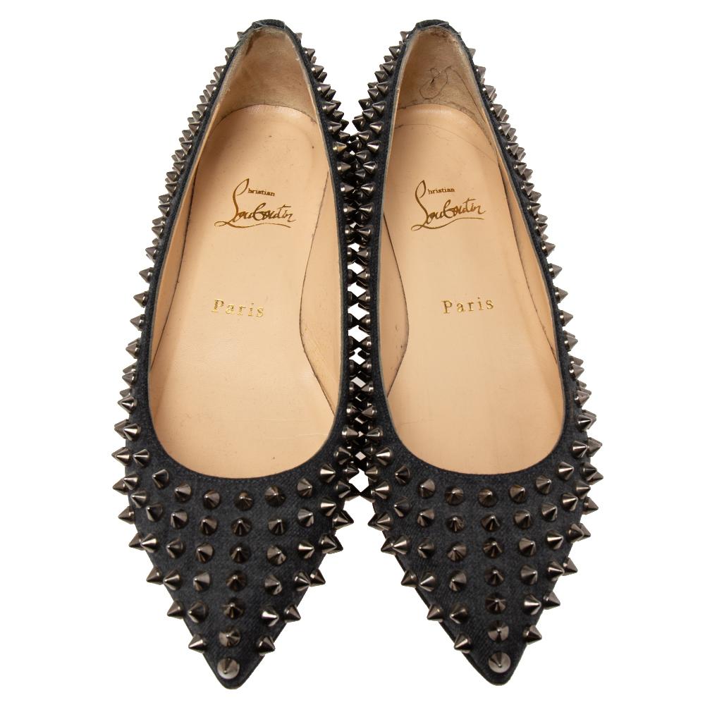 Get a statement look and comfort when you wear these ballet flats from the fashion house of Christian Louboutin. Made from black canvas, these flats are ornamented all over with spikes. These ballet flats come with pointed toes and have leather
