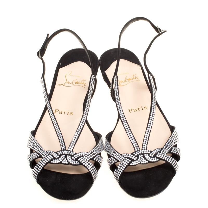 These flat sandals from Christian Louboutin are perfect to adorn your feet with elegance! The black sandals are crafted from suede and feature an open toe silhouette. They've been styled with intertwined vamp straps that are beautifully embellished