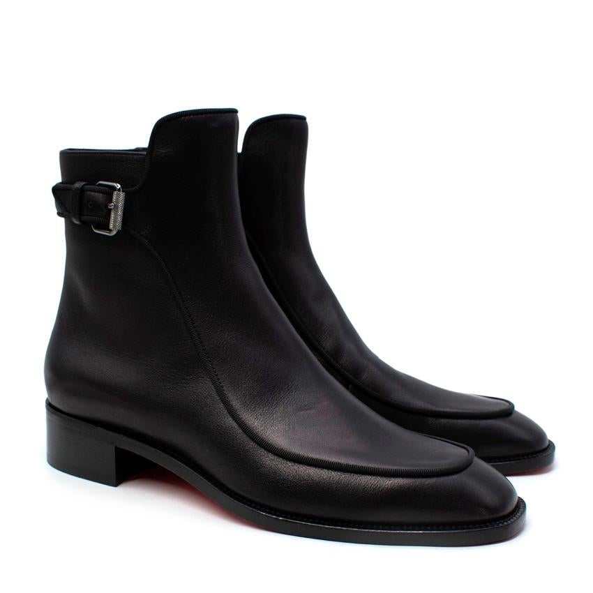 Christian Louboutin Black Ecritoir Leather Ankle Boots
 

 - Classic, smooth black leather ankle boots with a sculpted upper, decorative ankle strap, and grosgrain edging
 - Smooth signature red sole, and low block heel
 

 Materials 
 100% Leather