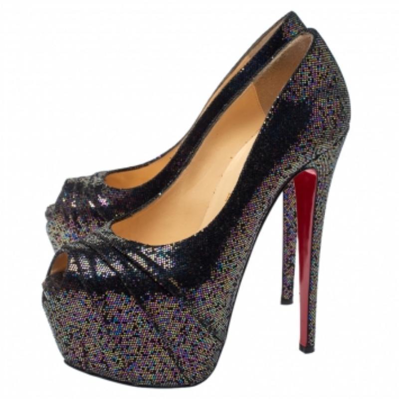 Stun the crowd when you wear these 160 Spotlight pumps by Christian Louboutin! They are made from black-hued glitter fabric and feature the signature red soles. These 16 cm high heeled platform pumps are leather-lined with the brand logos.
