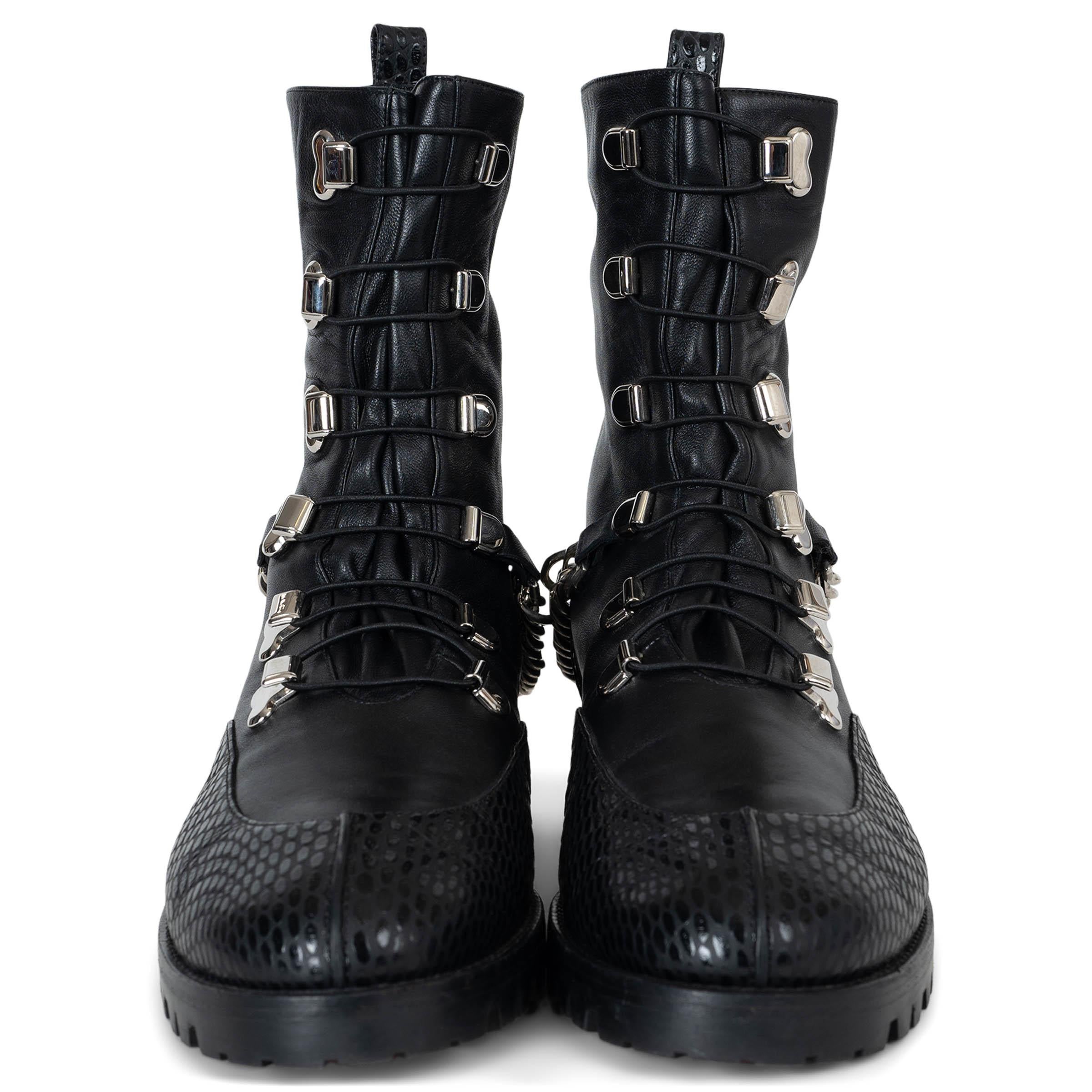This 100% authentic Christian Louboutin Guarda Chain combat boots in black smooth calfskin with snake-embossed trims exude bold sophistication. Designed with round toes, silver-tone metal hooks, and elastic bands over the vamp, they are elevated by