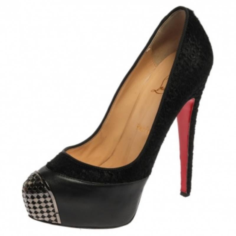 The impeccable shoemaking of Christian Louboutin never fails to impress! These stunning pumps feature a tonal colorway that enhances the black leather's texture in contrast with pony hair, and the cap toes are decorated with silver-tone hardware.