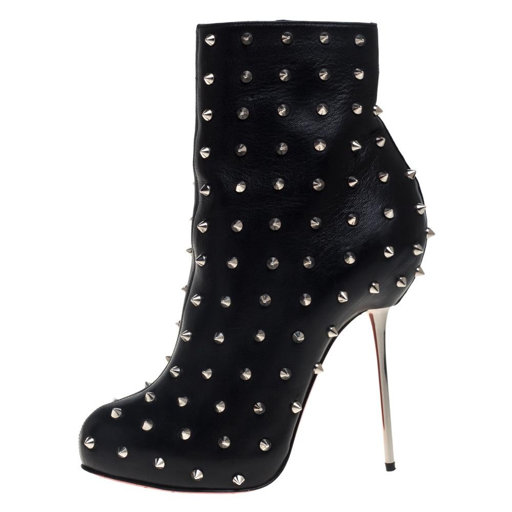 Enjoy the most fashionable days with these stylish ankle boots from Christian Louboutin. Modern in design and craftsmanship, they are fashioned in black leather and designed with side zippers, concealed platforms, 9.5 cm high heels, and spikes all