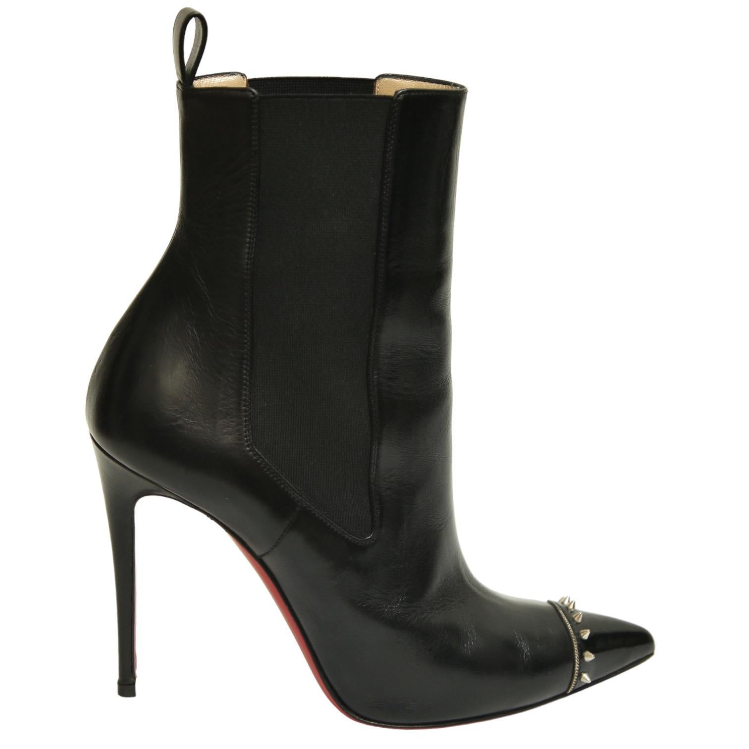 GUARANTEED AUTHENTIC CHRISTIAN LOUBOUTIN BLACK LEATHER BANJO SPIKED CAP TOE BOOTIES

Retail excluding sales taxes approximately $1,195

Details:
- Black leather uppers.
- Pointed cap toe with silver-tone spikes.
- Side elasticized pull on.
- Black