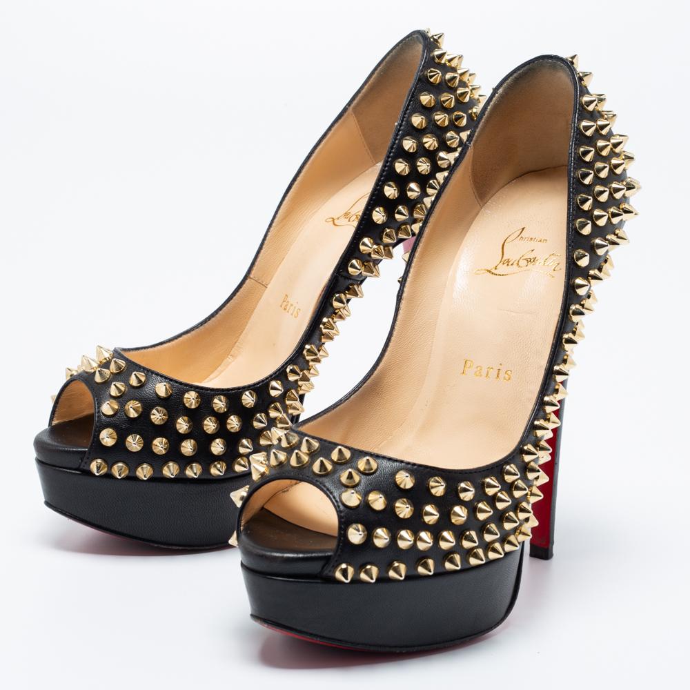 The House of Christian Louboutin brings an element of class to your closet with these stunning Lady Peep pumps. They are created using black leather and showcase peep toes, Spike accents, platforms, and tall heels. Make a fashion statement by
