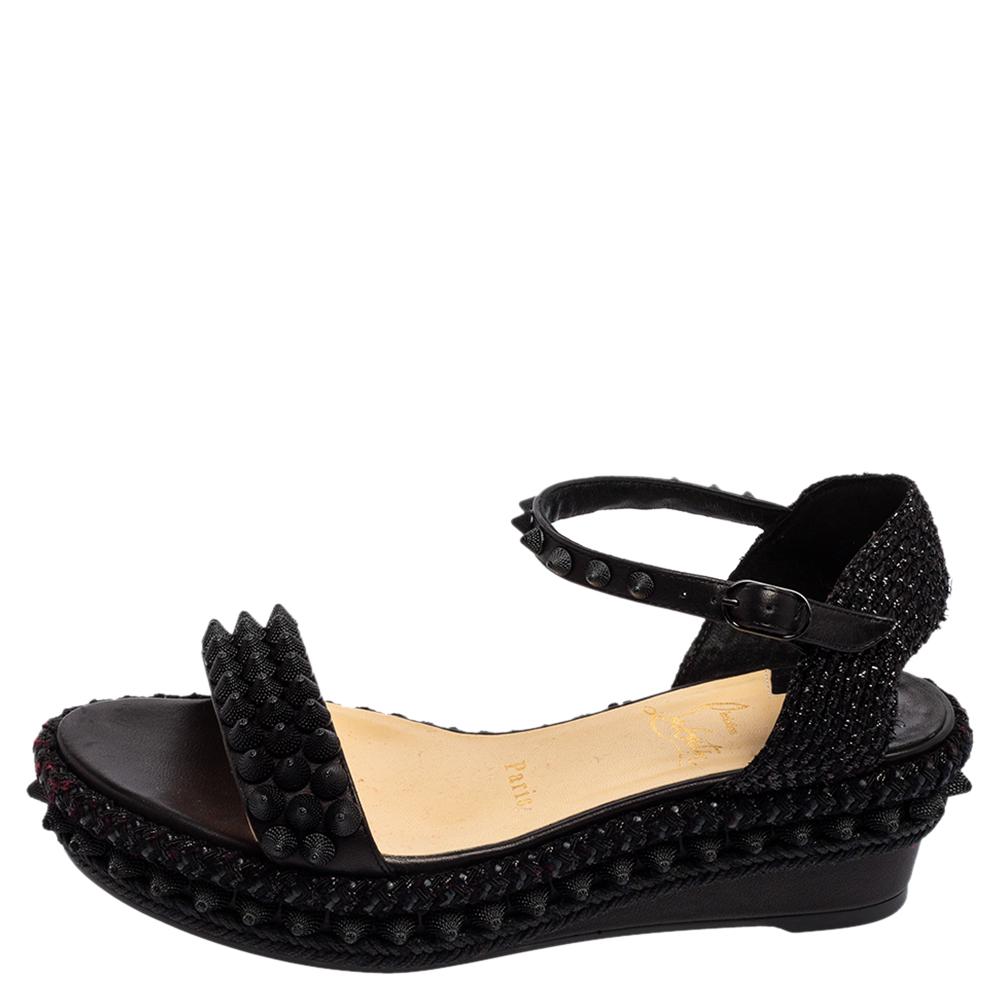 These Christian Louboutin sandals highlight a contemporary design that suits casual outfits effortlessly. Crafted from leather, the sandals come in black with spike decorations, ankle fastening, and durable soles covered in the signature