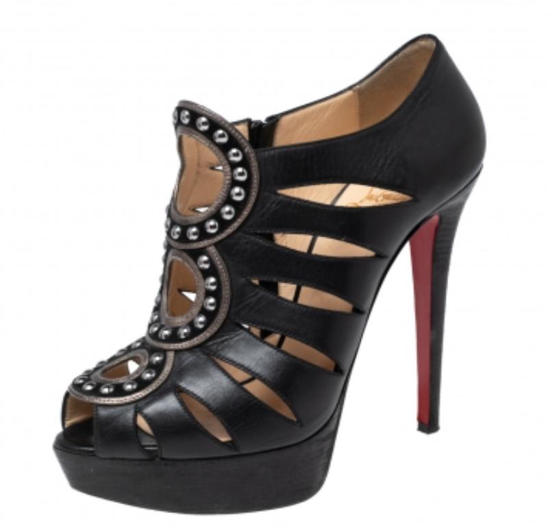 An exceptional flair and a chic appeal characterize these Maralla booties from Christian Louboutin. They are designed using black leather, which is enhanced with studded accents and cut-outs. They showcase slender heels and red soles. Elevate the
