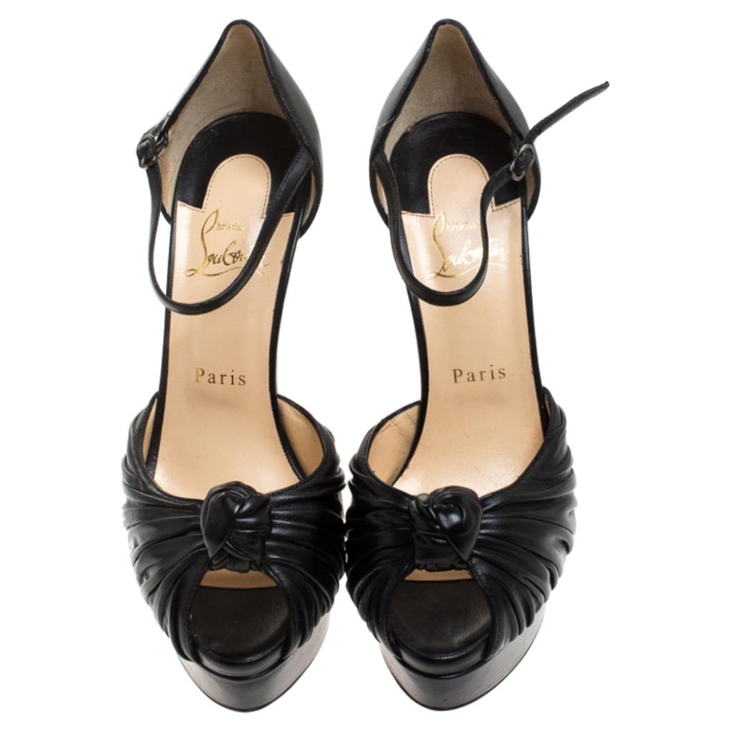 Beauty flows out of these Marchavekel sandals from Christian Louboutin! Crafted from leather, these sandals have a team-it-with-all black hue, knotted gathering over the toes, closed counters with buckle straps and towering 14.5 cm heels to help you