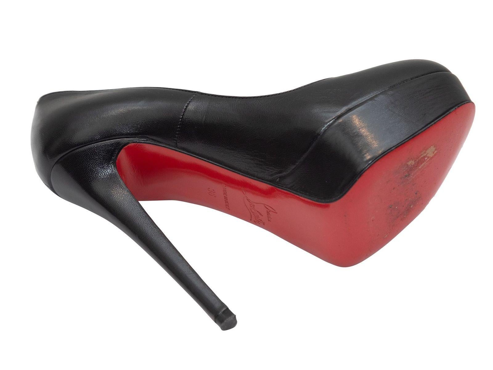 Product Details: Black leather round-toe platform pumps by Christian Louboutin. 1.25