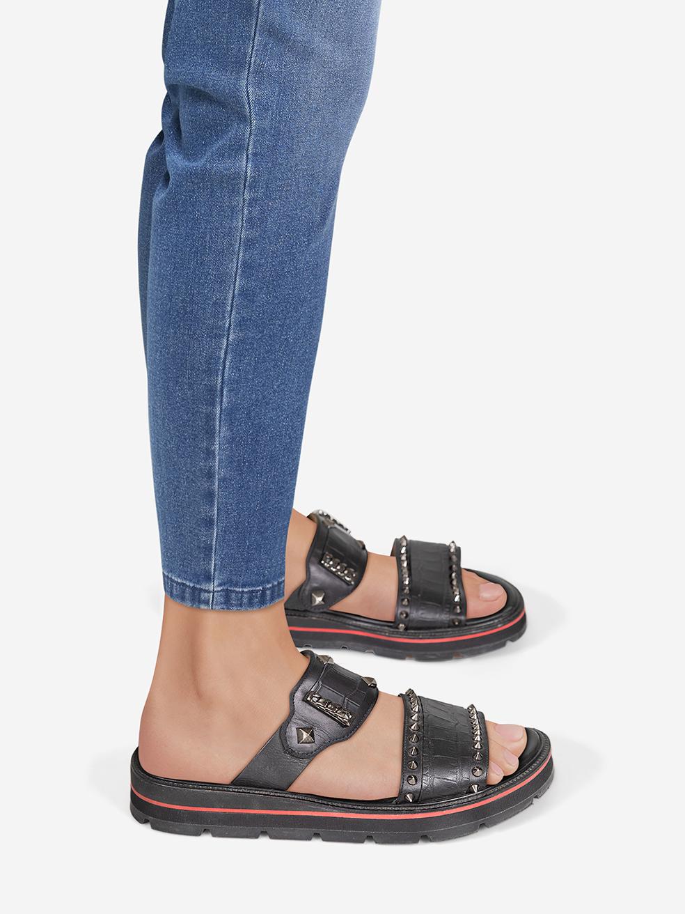 CONDITION is Very good. Minimal wear to the slides is evident. Abrasion on the upper foot strap and insole on both shoes on this used Louboutin designer resale item.
 
 Details
 
 
 Black
 
 Leather
 
 Sandals
 
 Studded detail
 
 Gun metal tone