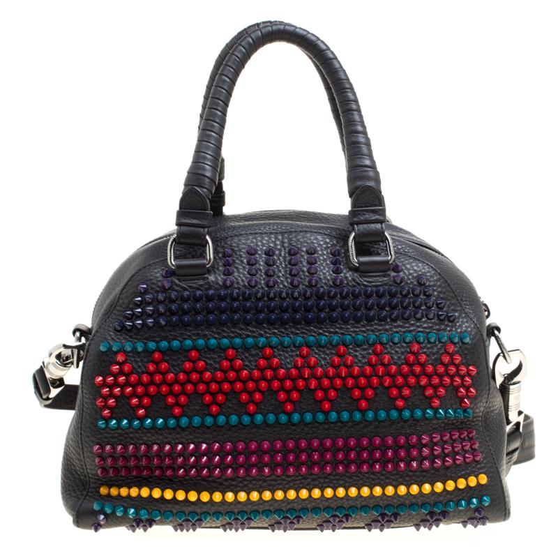 This super-amazing bowler bag from Christian Louboutin is not only artistic in design but also high on style. Crafted from leather, the black bag features a contemporary and edgy silhouette. It flaunts multicoloured spikes studded at the front and