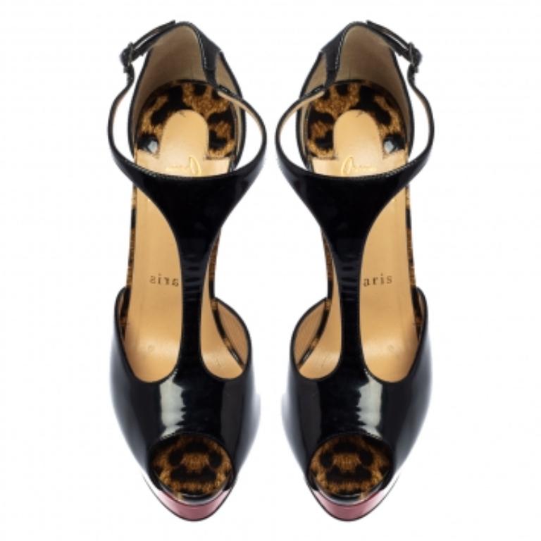 Christian Louboutin's Jilopa sandals stand on a sky-high stiletto heel. Made in Italy from black patent-leather, this polished pair has a red lacquered sole and a slim T-bar strap. These unbelievably gorgeous sandals feature peep toes and platforms