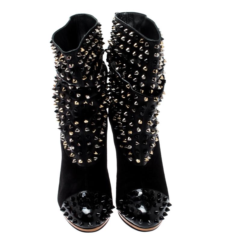 These stunning Spike Wars boots from Christian Louboutin are contemporary, edgy and quite stylish! The black ankle boots are crafted from soft suede and patent leather and feature round toes. They have been styled with spikes on the shaft and cap