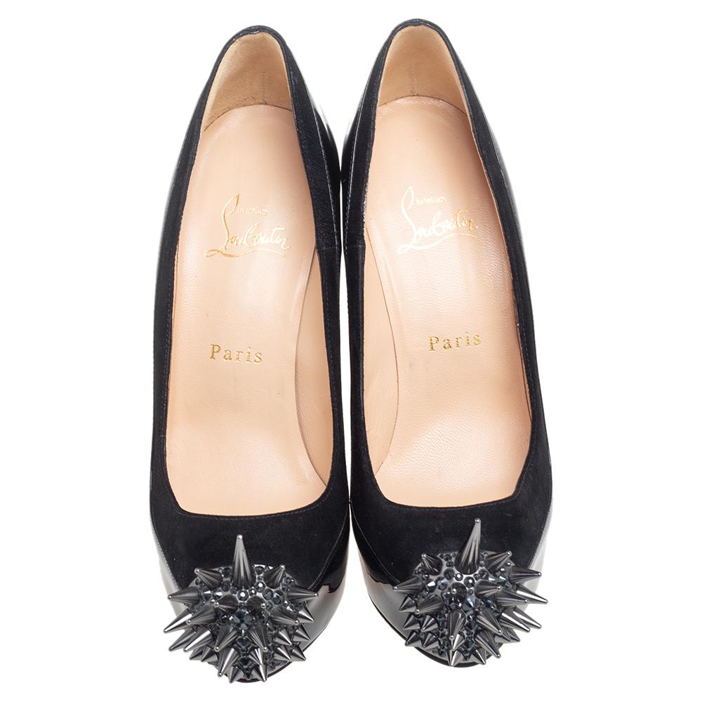 Jazz up your attire with this pair of Asteroid pumps designed by Christian Louboutin. Crafted from patent leather and suede, these black ones are styled with platforms, high heels, and metal spikes on the toes. This pair of beauties has a glamorous